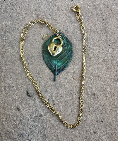 Yellow gold, brass locket, moldavite leaf pendant 18” necklace