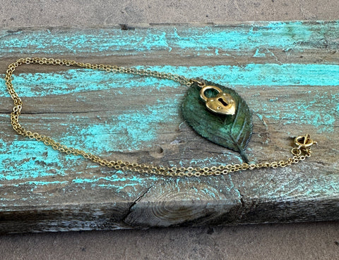 Yellow gold, brass locket, moldavite leaf pendant 18” necklace